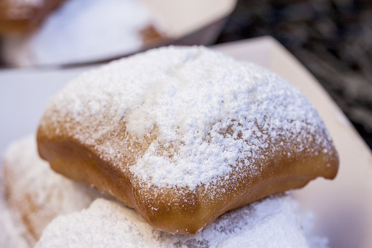 A traditional New Orleans Beignet covered in powdered sugar